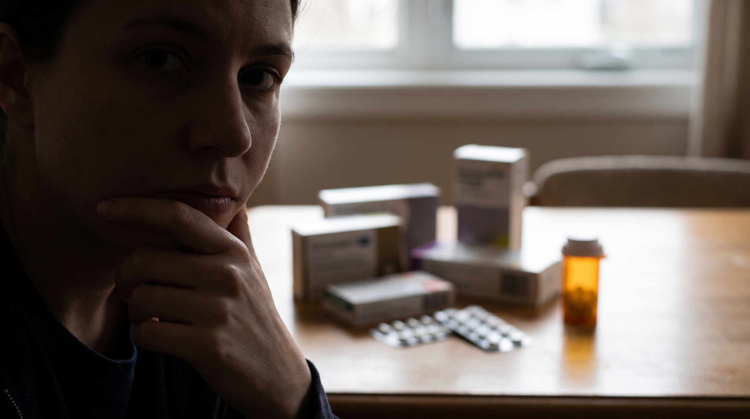 A person contemplating the effects of GLP-1 medications on hair loss.