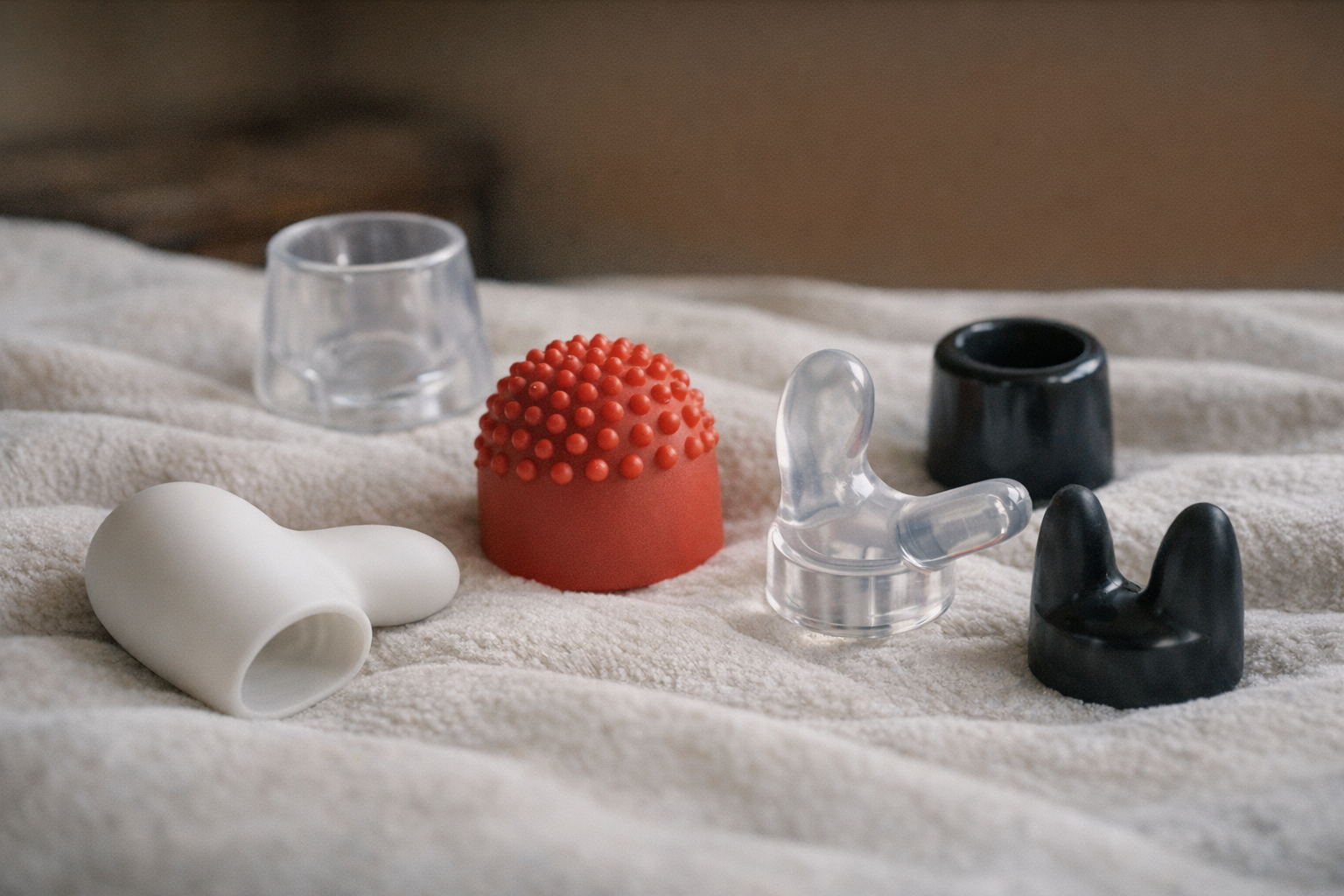 Various Magic Wand attachments on a soft surface