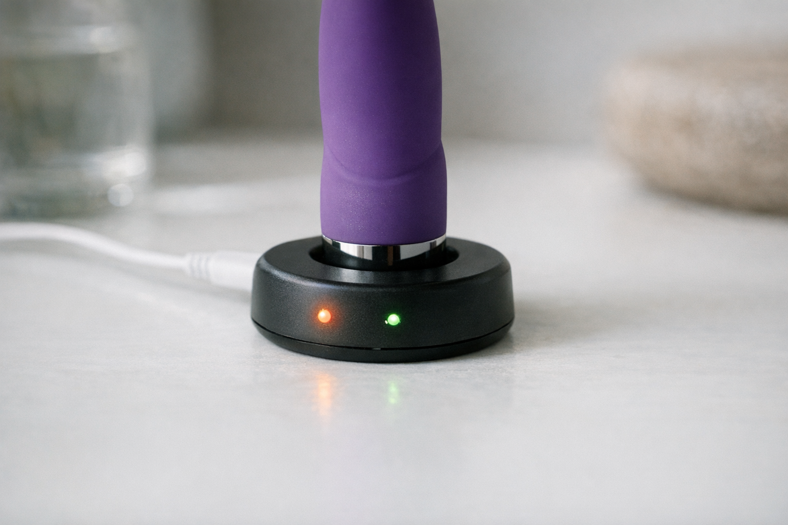 A plusOne Vibrator Charger on a surface