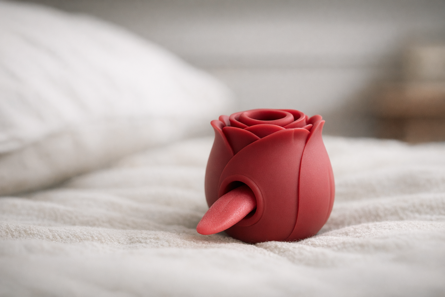 Rose toy with tongue on a soft surface