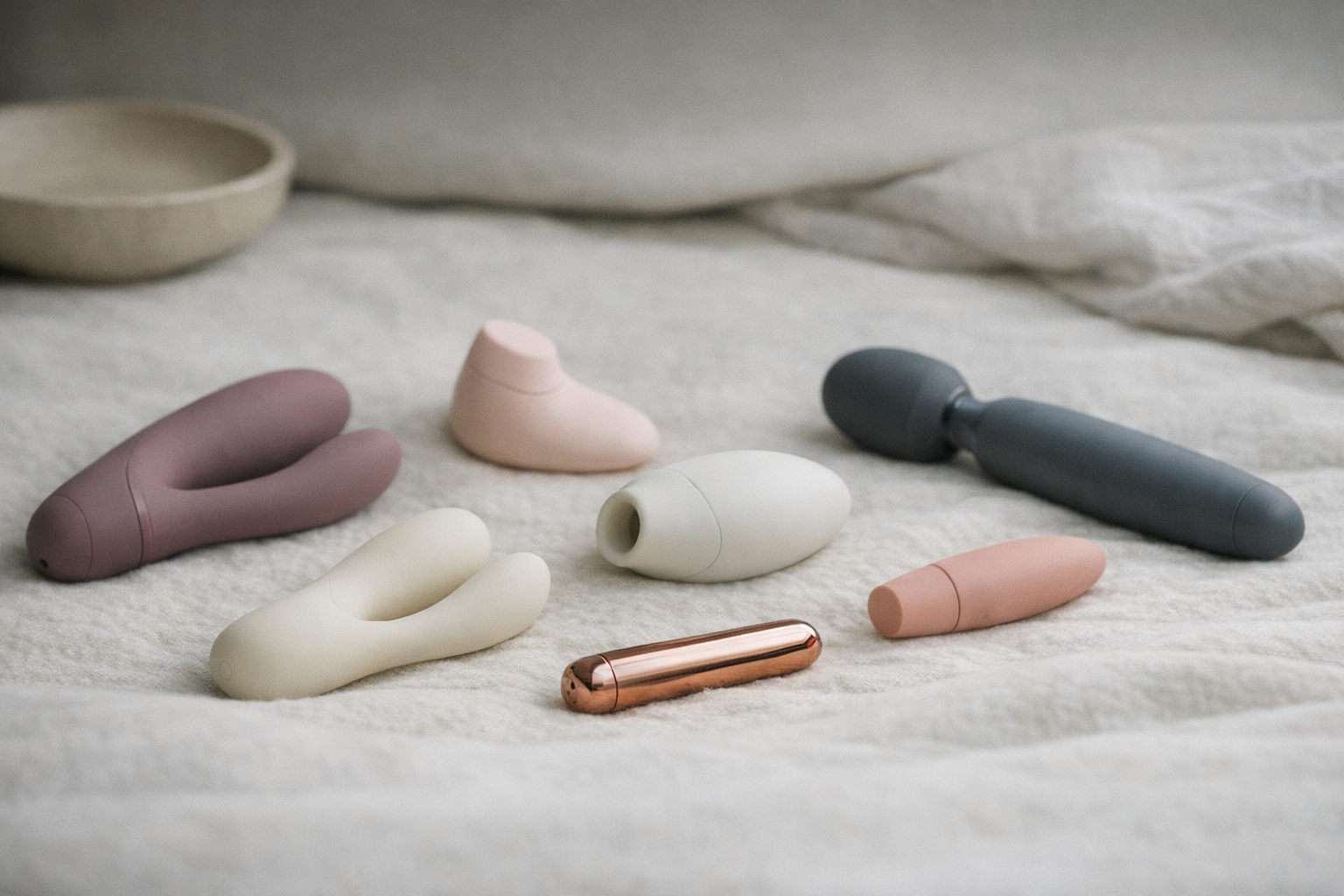 A collection of quiet vibrators showcased on a soft surface.