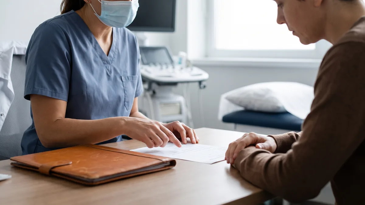 A healthcare professional explaining A1C levels to a patient.